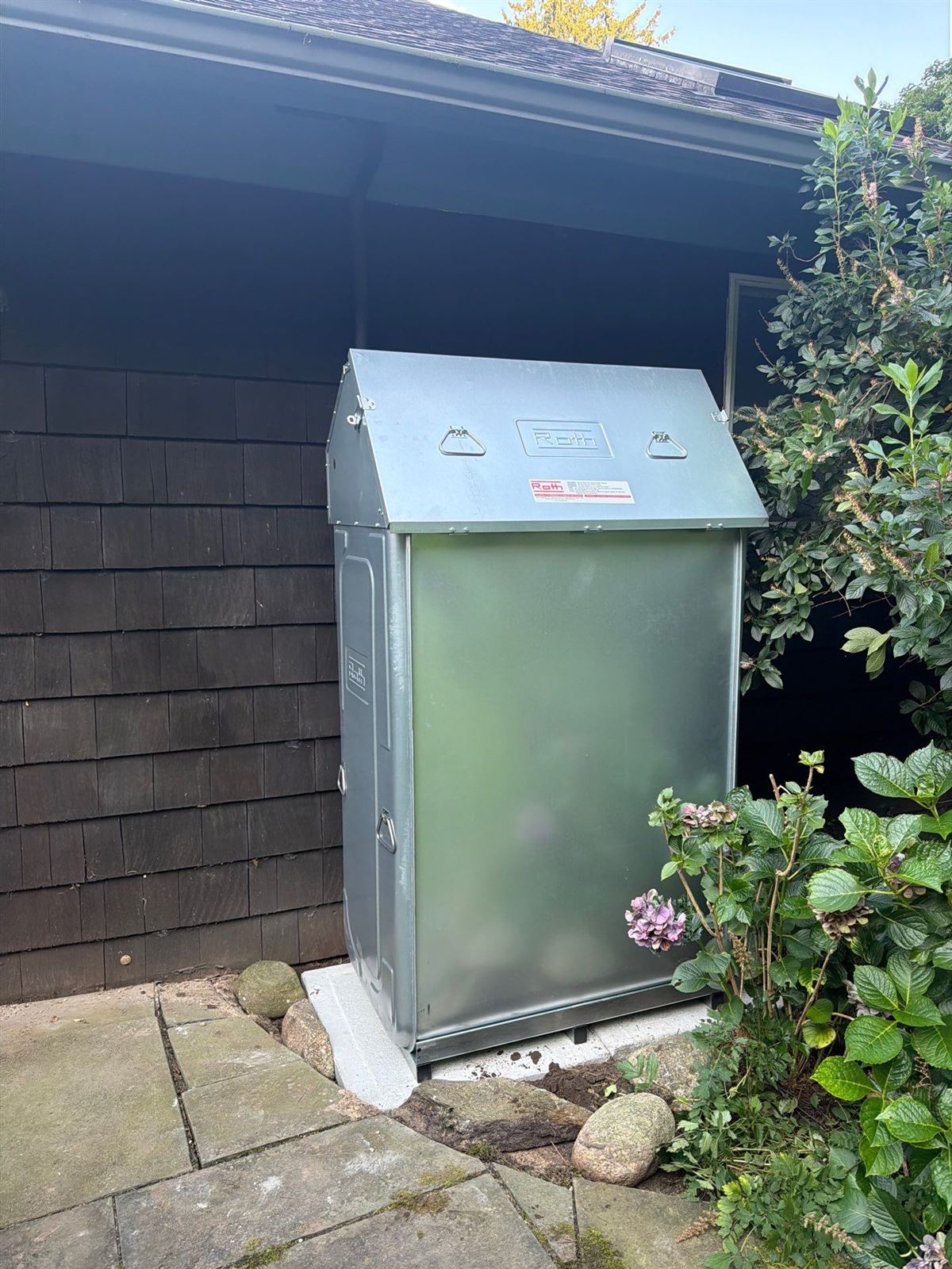 Roth double-wall oil tank installed beside a shingled home
